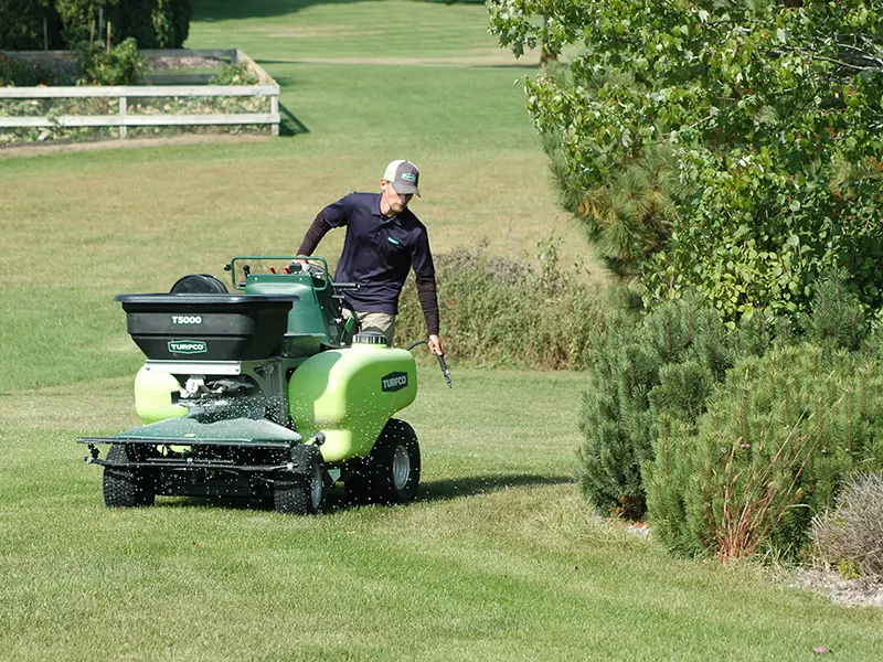 Lawn care technician treating a yard
